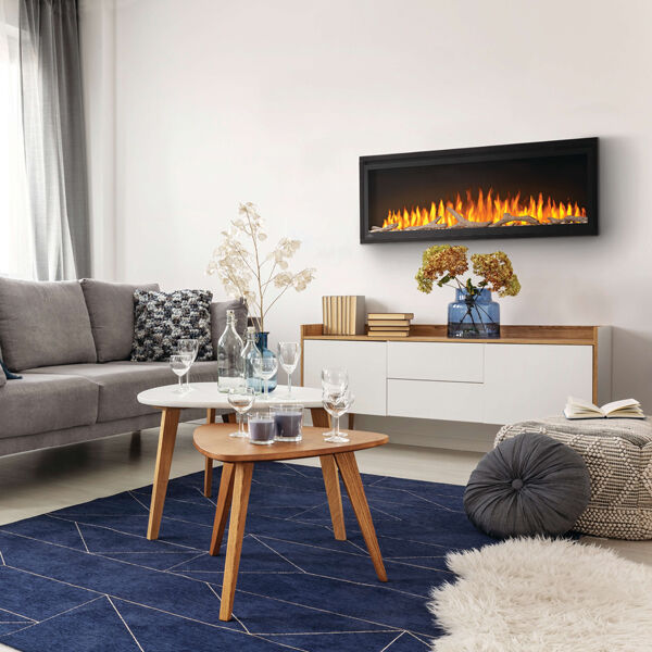 The Napoleon Entice electric fireplace in a modern living room with a beige couch, a navy blue accent rug, white walls, and modern wood furniture. 