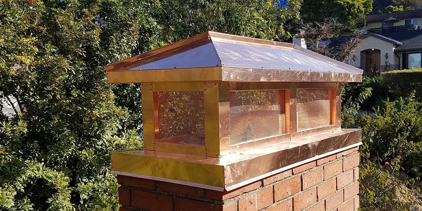 A custom decorative copper chimney shroud by the brand American Chimney Shroud
