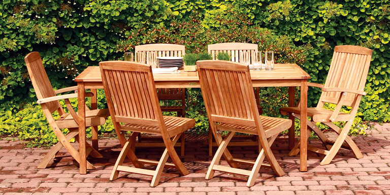 An outdoor dining set with a table and six chairs made of durable wood