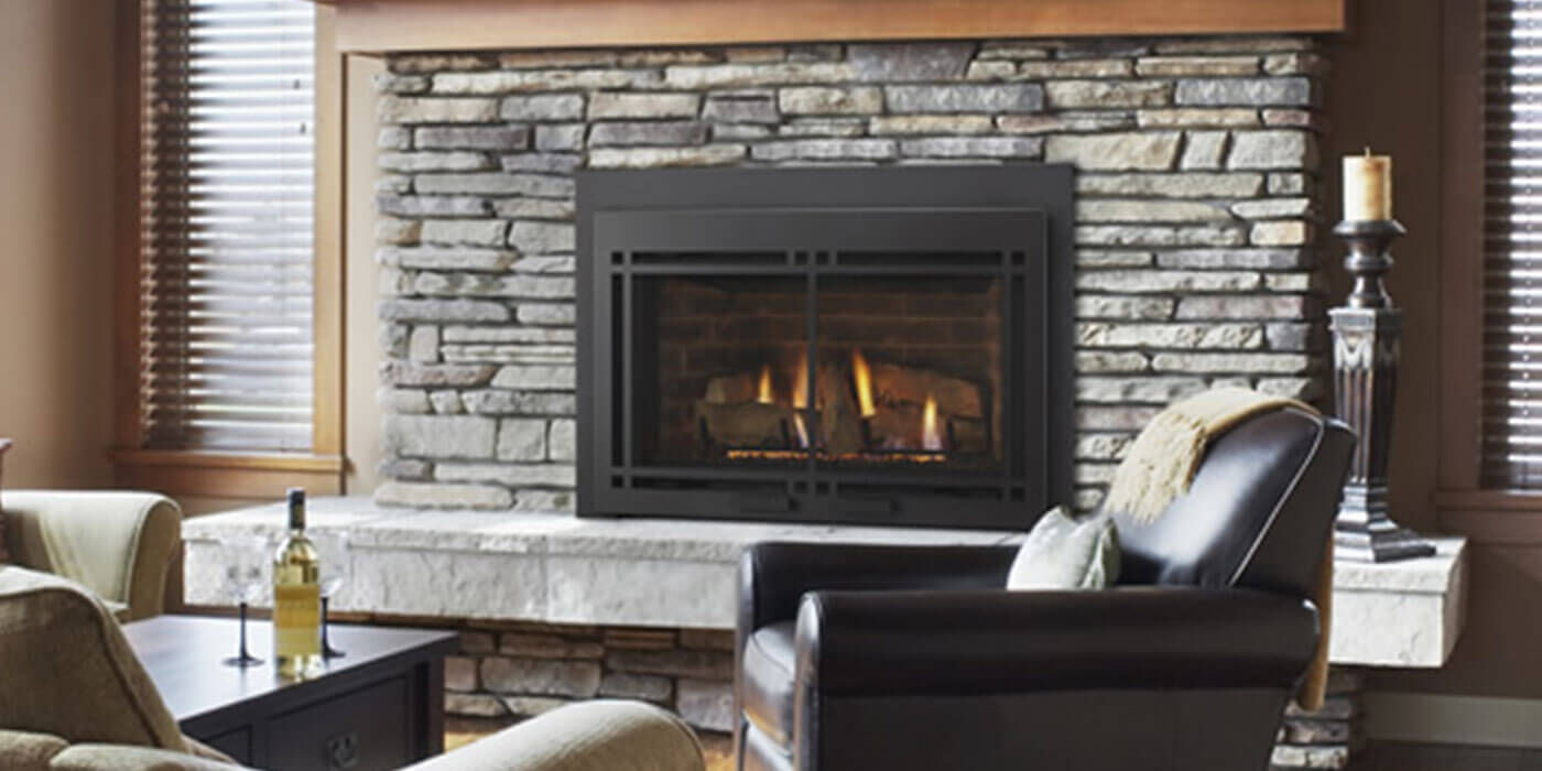 The Majestic Ruby Direct Vent Gas Fireplace Insert has a wide, ceramic glass front that radiates heat, a realistic Split Wood log set, a variable speed blower, and touch-screen controls.