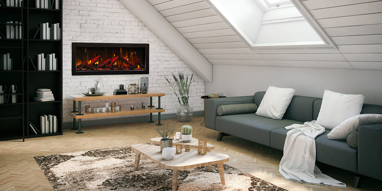 A small living space with a green couch, large black bookcase, and a linear electric fireplace built into the wall