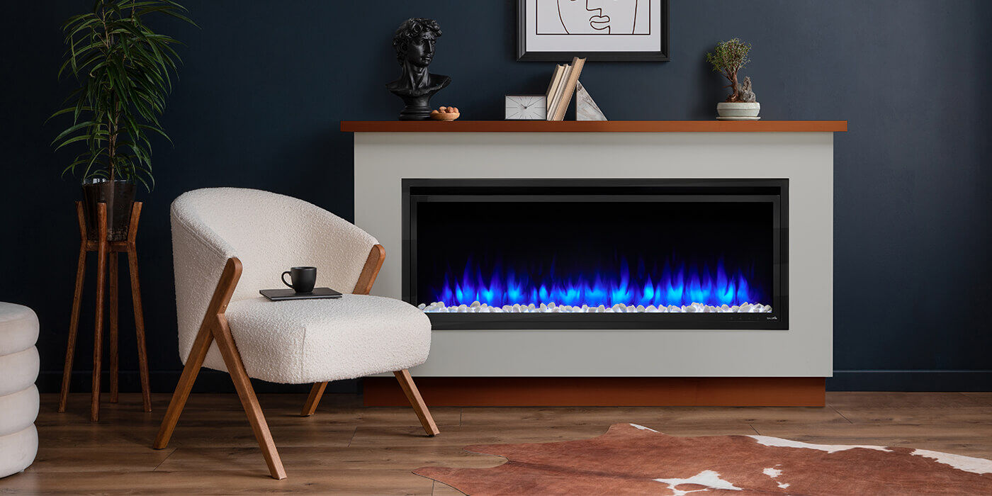 A linear electric fireplace with blue flames, built into a custom enclosure with a mantel