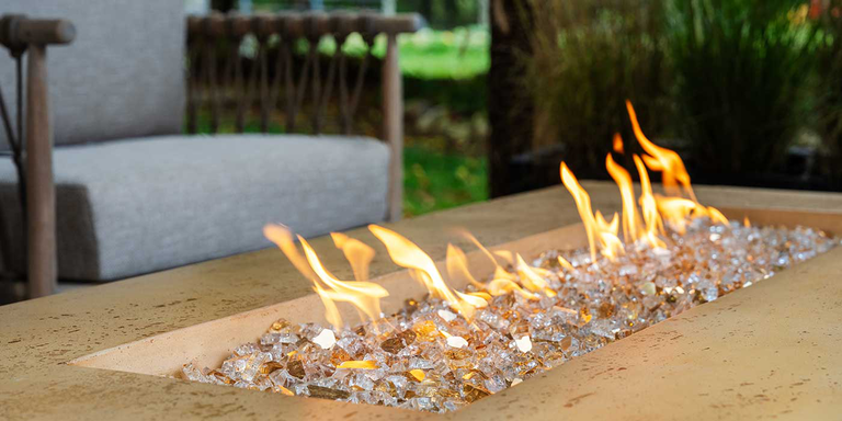 The Tuscan Gas Fire Pit with reflective Copper colored fire glass media and soothing, campfire-like flames