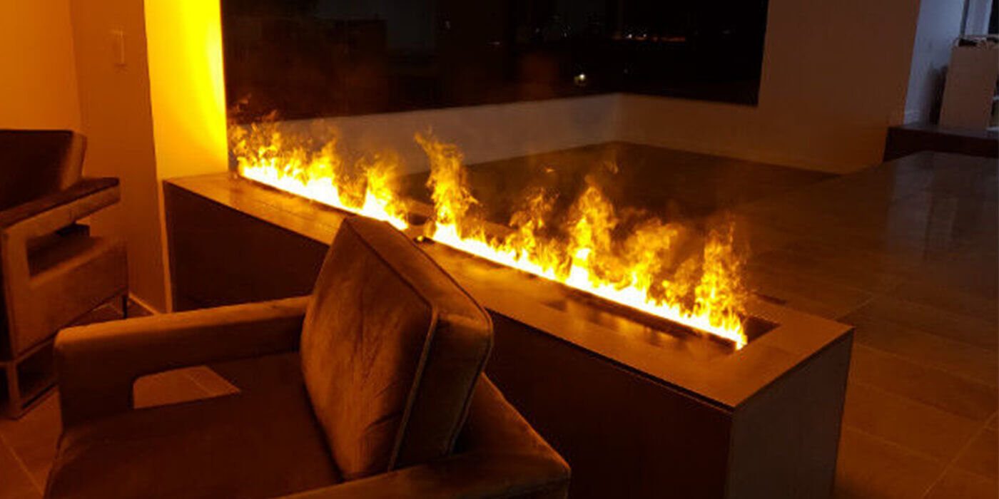 A chair in front of an OptiMyst fireplace in a dark living room