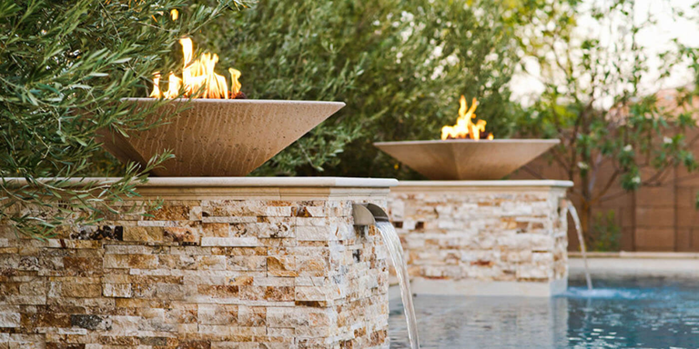 Two fire and water features near a pool