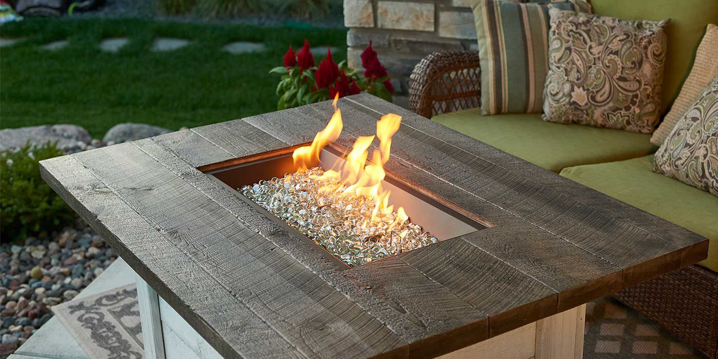 A fire pit table with clear fire pit glass media