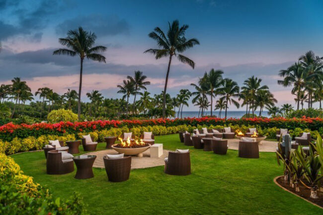 Sunset view of gas fire bowls at a Hawaiian resort