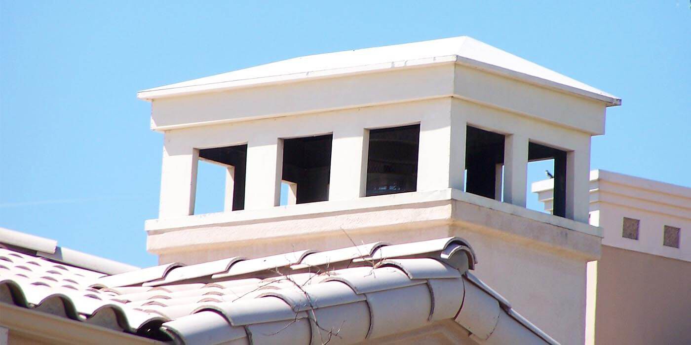 A decorative white chimney shroud by American Chimney Shroud