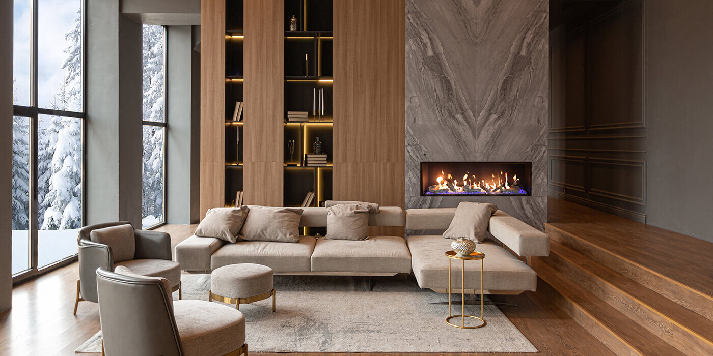 A rustic indoor living space with a large, linear gas fireplace