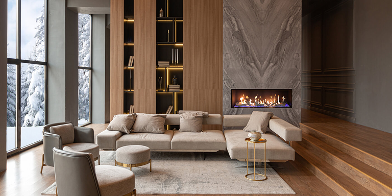 A rustic indoor living space with a large, linear gas fireplace