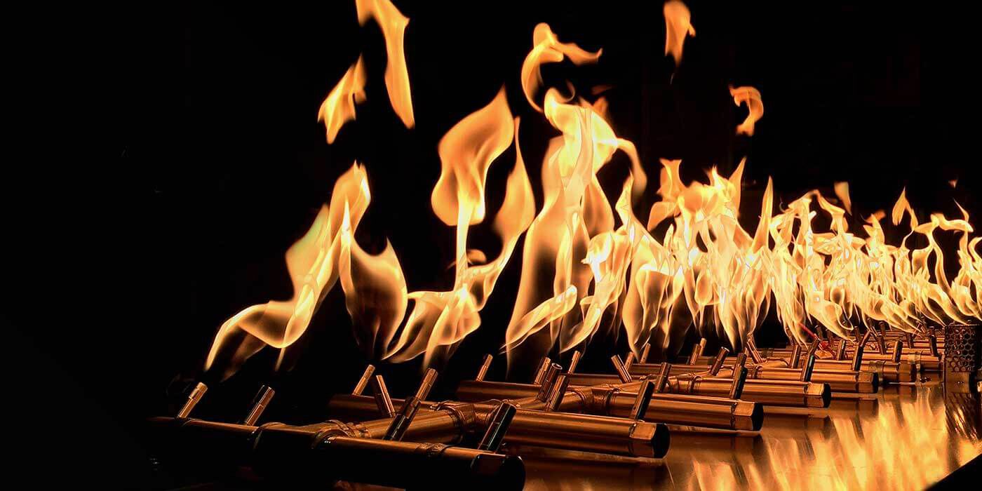 Warming Trends' linear brass burner kit with welded, raised ports and tall, golden flames.