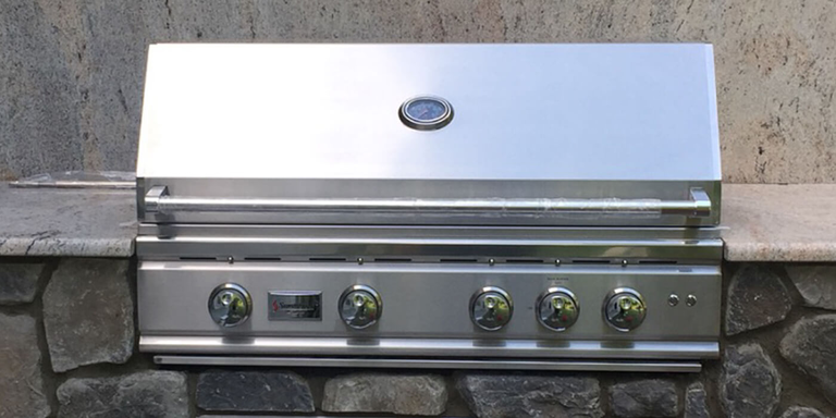 An outdoor kitchen island finished with stone veneer