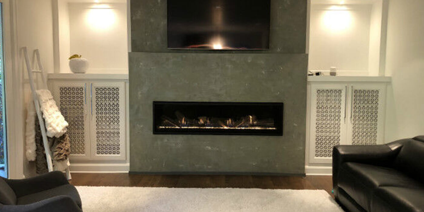 Modern living room with gray cement hearth and black linear fireplace