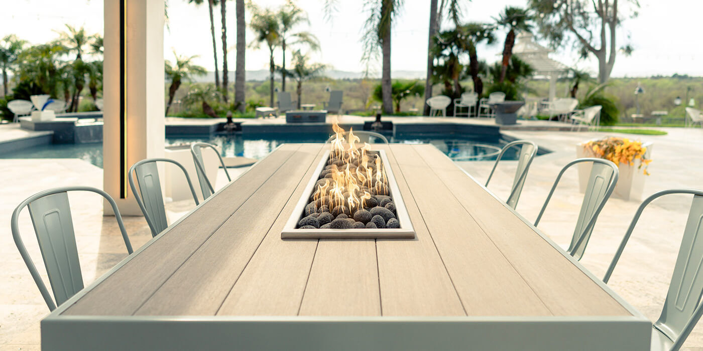 An outdoor fire pit dining table An outdoor fire pit dining table