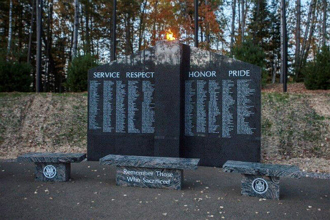 Large dark gray ganite veteran memorial in the woods