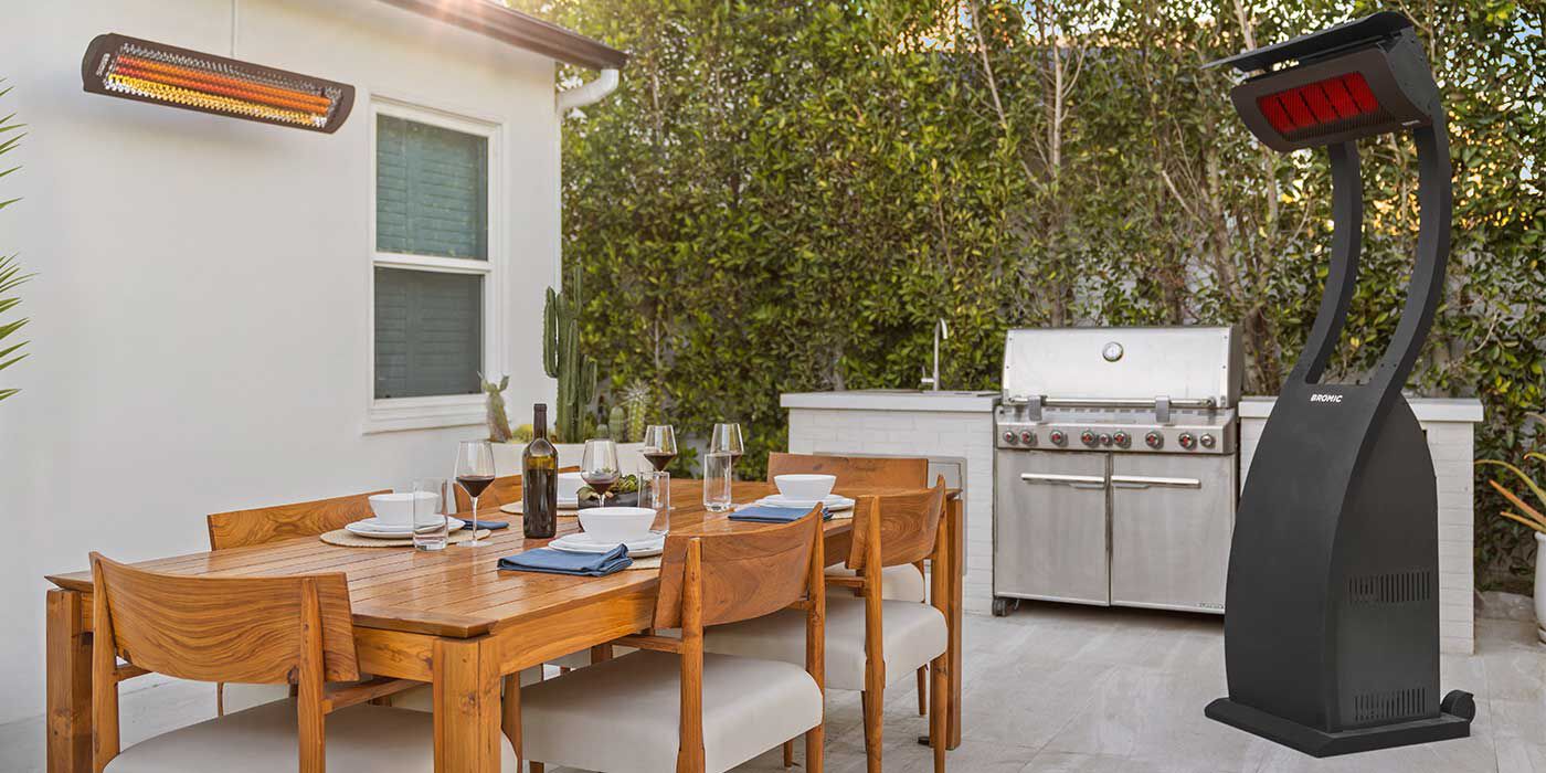 An outdoor dining space with a freestanding Propane heater and a mounted gas heater on the wall