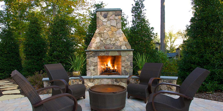 A Standard Isokern outdoor fireplace finished with natural stone.