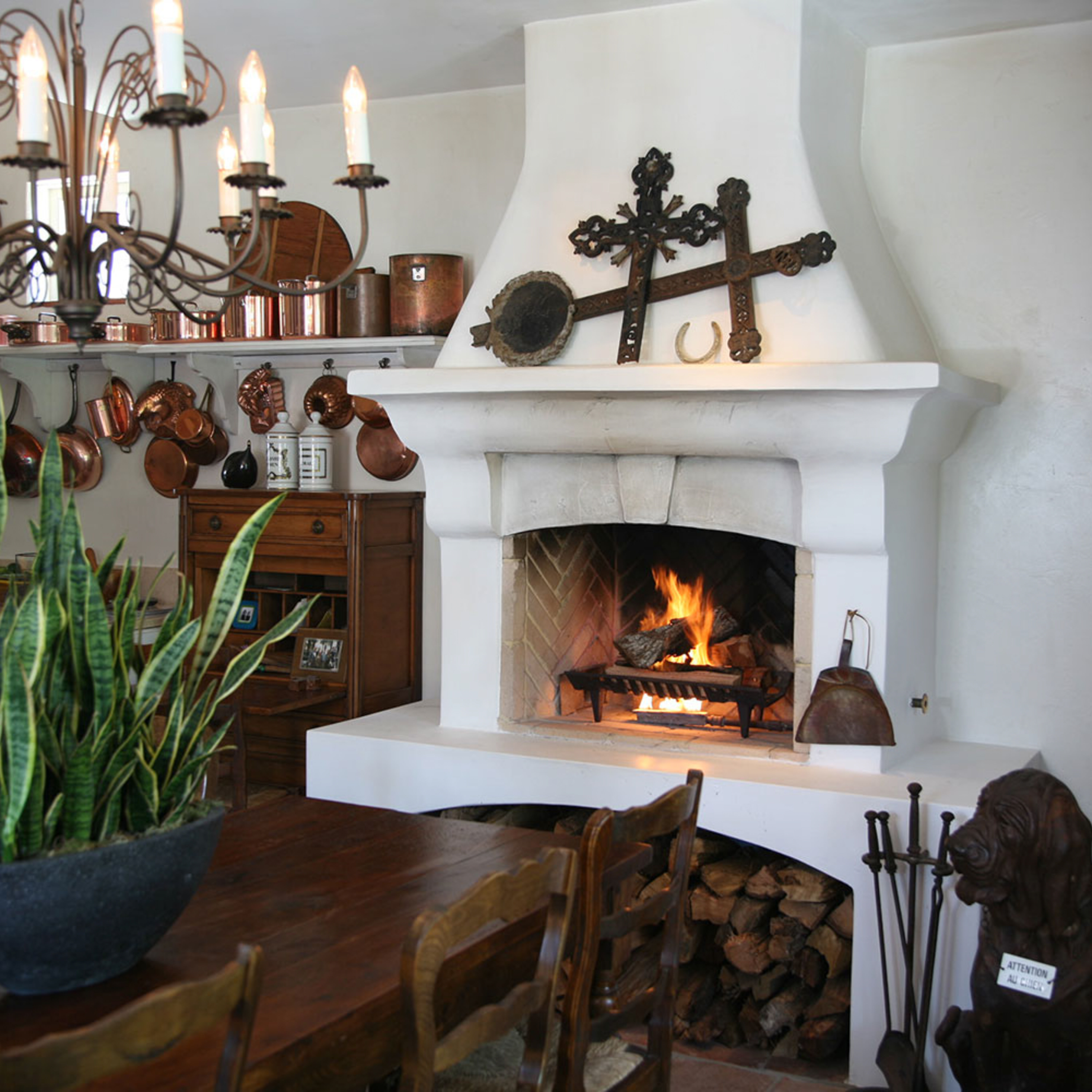 this is a photo of a traditional masonry fireplace hearth with a chimney, a log set, and chimney components