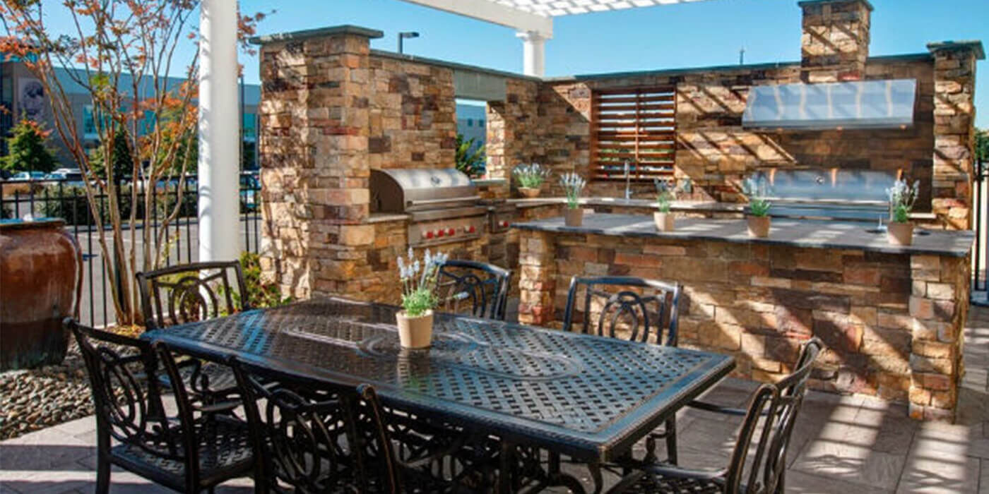 Urban outdoor kitchen island inset with gas grills