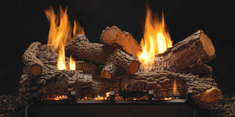 A Ventless gas log set burning on top of a modern black fireplace grate.