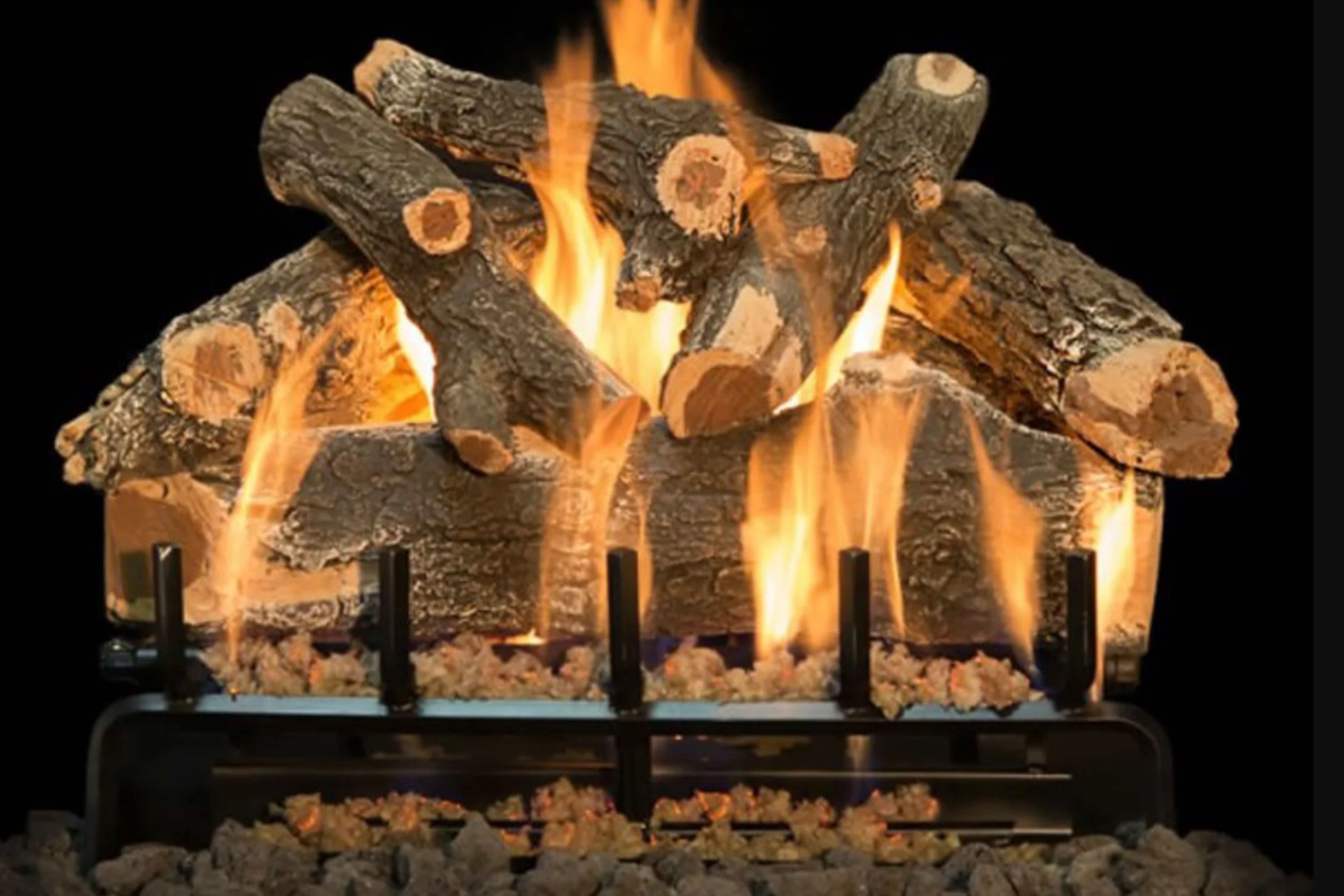 A stack of Vented Arizona Weathered Oak gas logs with rustic bulges, knobs, and cracks on a black background. 