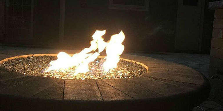 Close-up of flames in a fire pit at nighttime