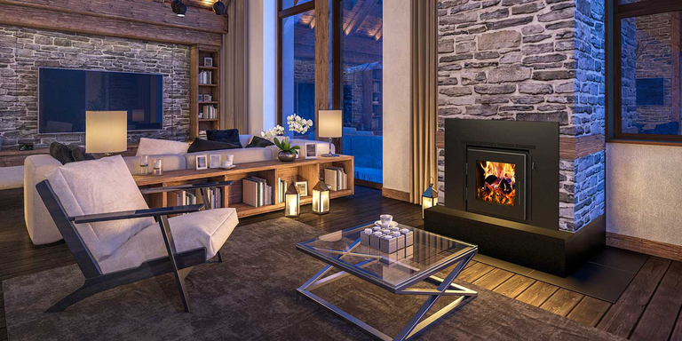 A rustic indoor living room with a large, stone hearth and a wood stove insert with a wide, black steel frame.