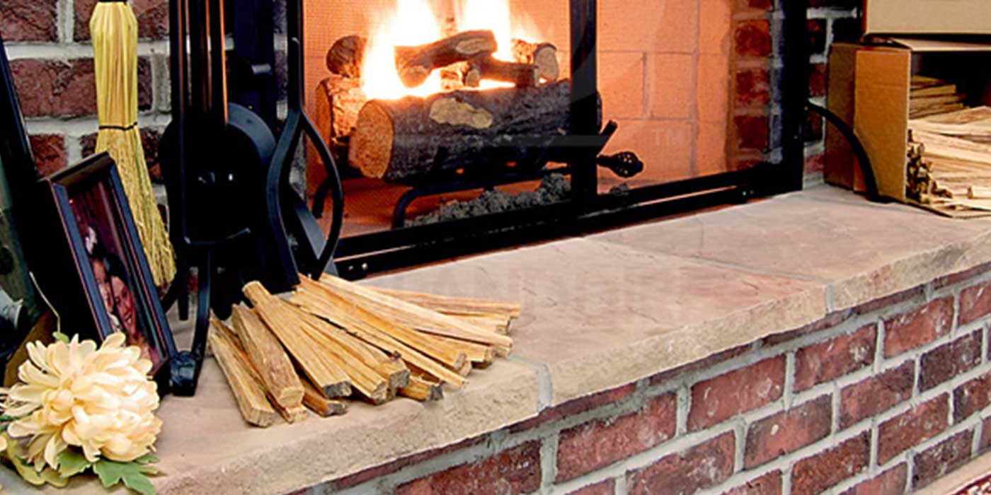 A traditional, brick wood burning fireplace with a pile of fatwood firestarter sticks