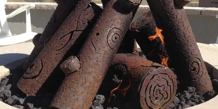 A stack of outdoor metal gas logs 