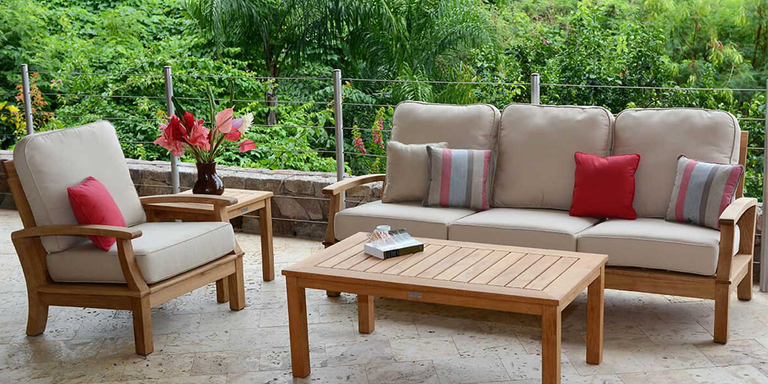 An outdoor space with a sofa, armchair, coffee table, and side table