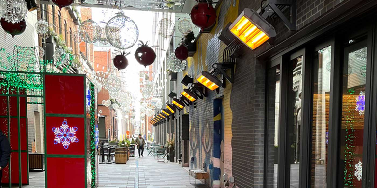 An outdoor shopping center with Detroit Radiant patio heaters