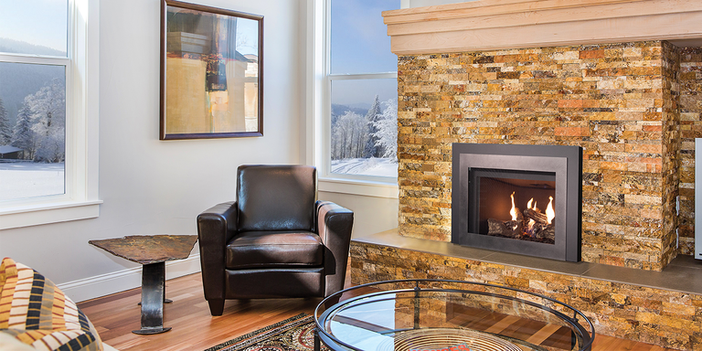 A contemporary living room with a natural stone hearth and a high-efficiency wood burning stove insert from Ironstrike