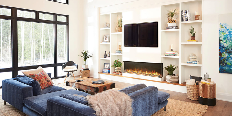 A modern living room with a large, linear electric fireplace built into a wall with a TV and custom shelving