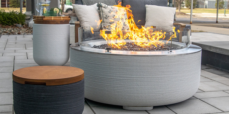 The FlameCraft ReForm Stack Gas Fire Pit with a matching Propane tank enclosure side table.