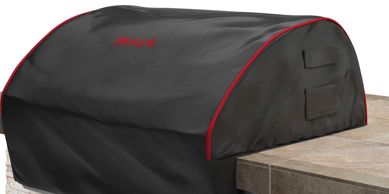 A bbq grill with a black cover on it