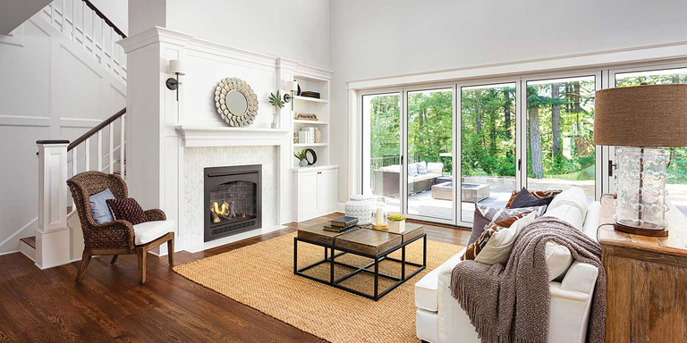 A large, rustic living room with a traditional Napoleon gas fireplace 