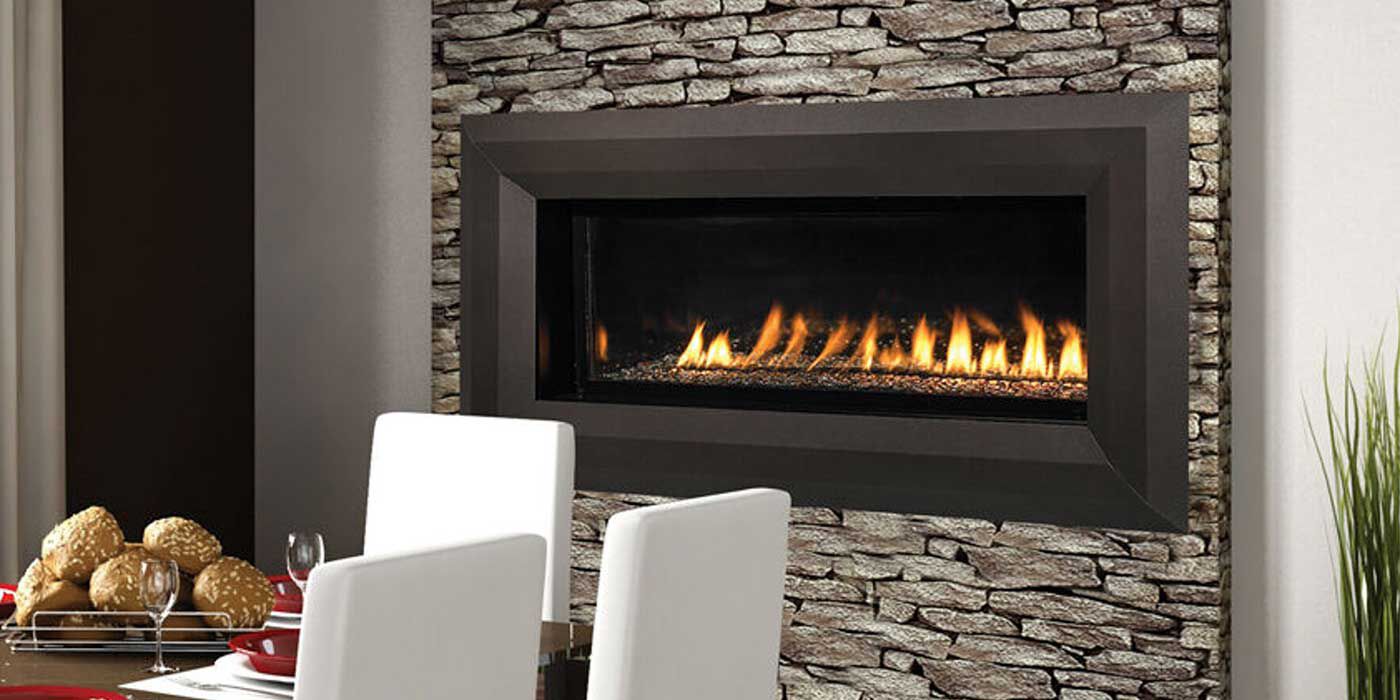 A traditional dining room with a natural stone feature wall and a linear, Ventless gas fireplace