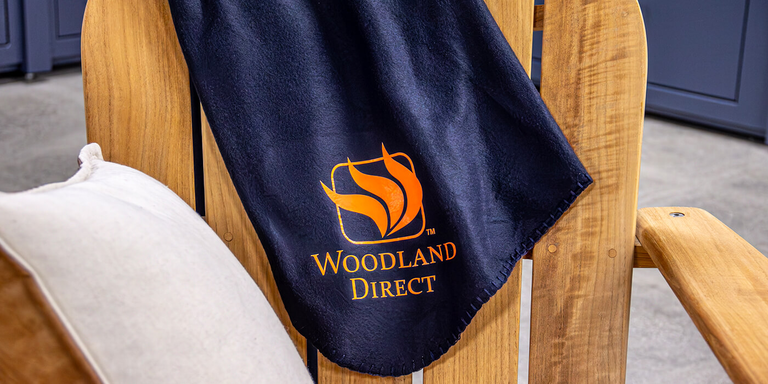Navy blanket with the Woodland Direct logo in orange 