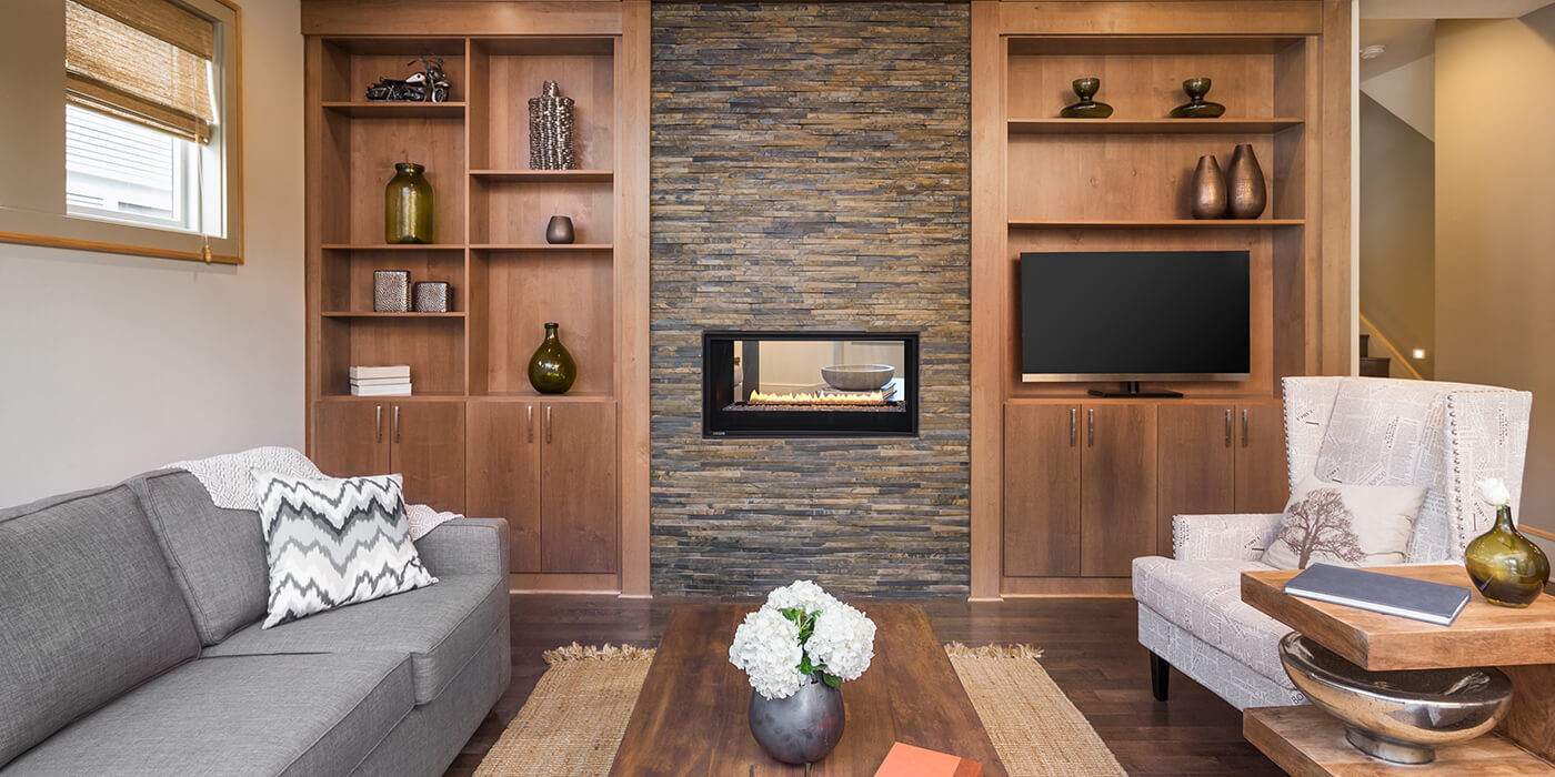 A linear see-through gas fireplace in a contemporary living room