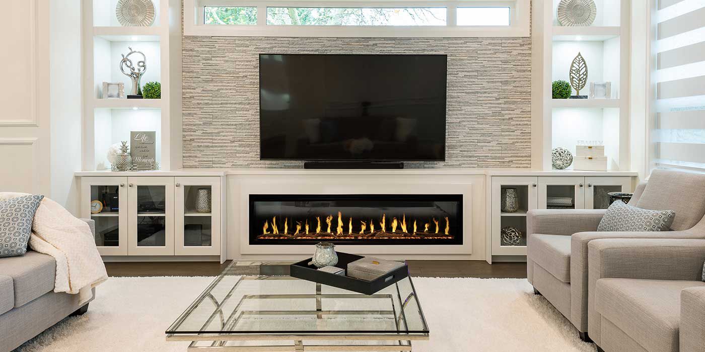 The Modern Flames Landscape Pro Slim Linear Electric Fireplace features lifelike electric flames installed in a contemporary living room 