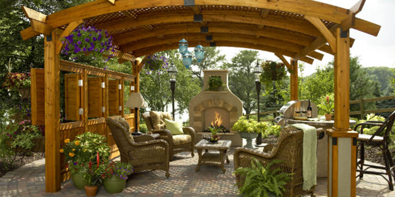 Day view of backyard patio with gas fireplace and pergola
