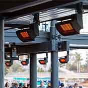 Ceiling-mounted patio heaters installed in an outdoor restaurant area