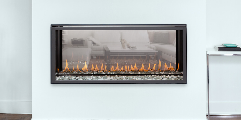 A linear see-through gas fireplace