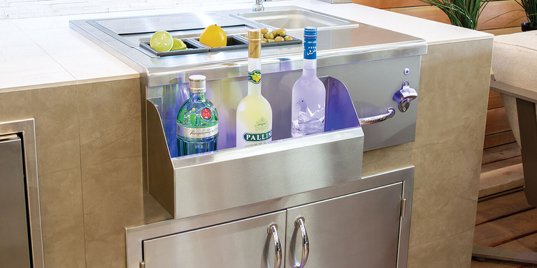 An outdoor beverage center with a sink and faucet, and storage space for drink garnishes 