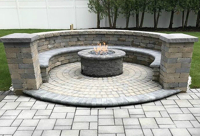 Masonry fire pit in the middle of a stone patio