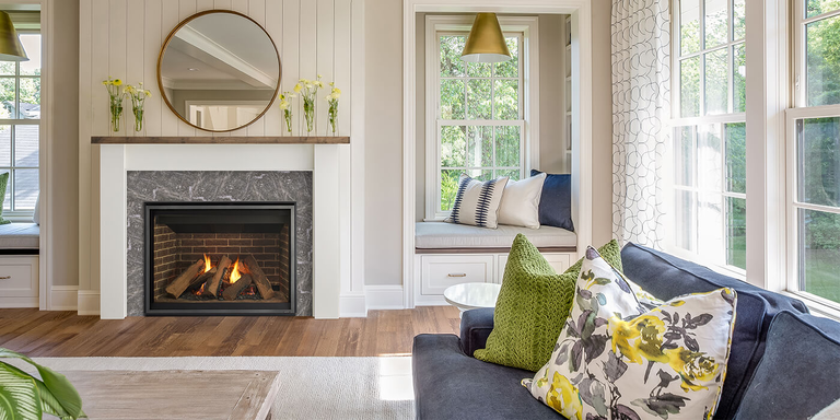 A contemporary indoor living room with a square, classic-looking gas fireplace 