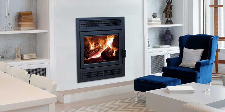 A modern living room with a traditional wood burning fireplace and a wood stove insert