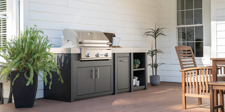 A small RTF outdoor kitchen island with a black finish and stainless steel grill.
