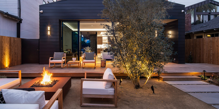 An outdoor living space with a seating area and fire pit 