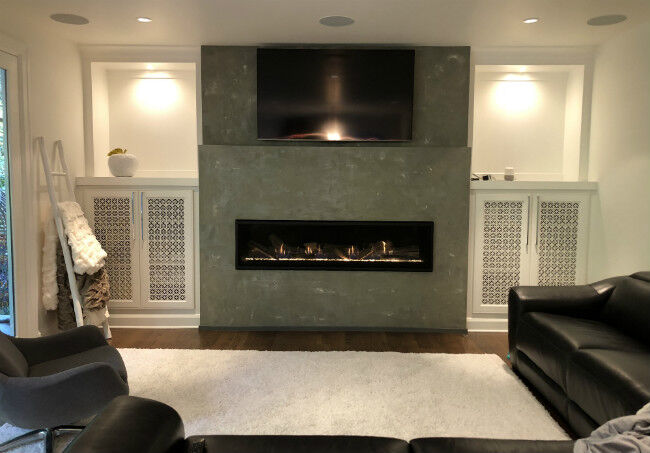 Modern living room with gray cement hearth and black linear fireplace